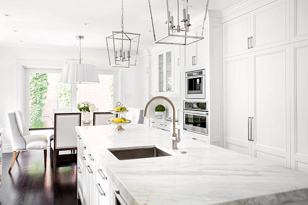 Bright Classic White kitchen Bright horizontal image of classic white kitchen, with marble island. breakfast room stock pictures, royalty-free photos & images