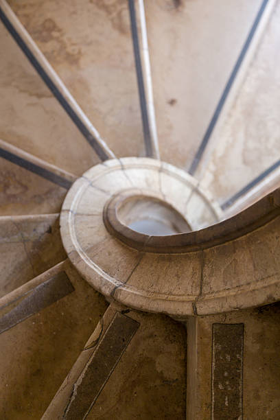 istock antique spiral ladder from marble stone 617893464