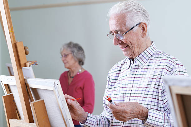 istock Seniors Attending Painting Class Together 617893560