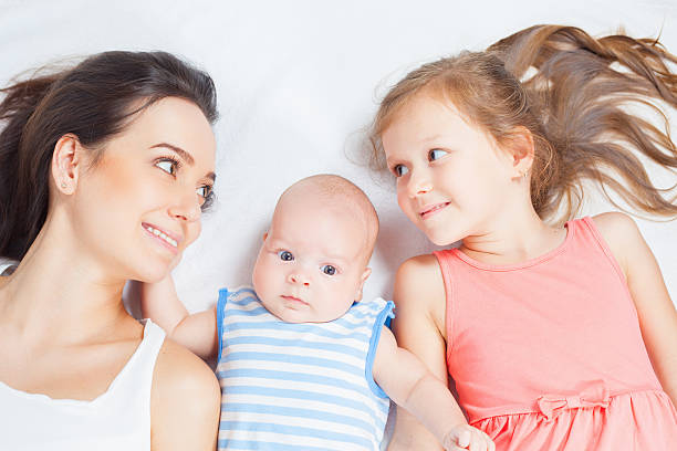 istock Happy mother with her children looking at camera 617893928