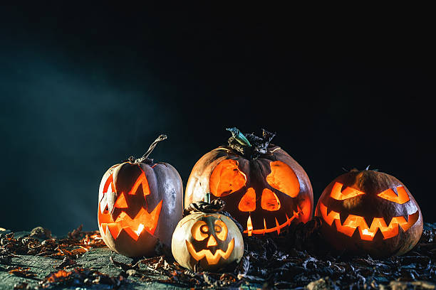 istock Halloween pumpkins at wood background. 617894172