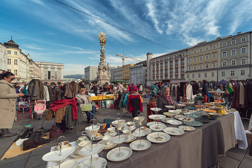 Linz, Austria - October 15, 2016: Cityscape of the town square in Linz, upper Austria, The flea market of curiosities is held all year round every Saturday from 7 am to 2 pm. On the town square are hundreds of market stalls of merchants selling mainly antiques.