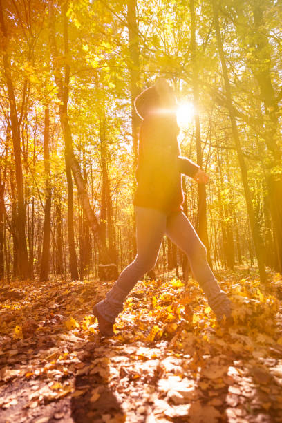 istock Woman in autumn park 617897500