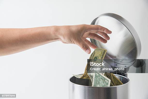 Throwing Away Dollar In Trashcan Stock Photo - Download Image Now - Currency, Garbage, Throwing