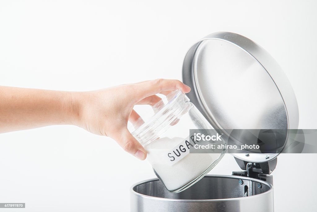 throwing away sugar in trashcan Escaping Stock Photo