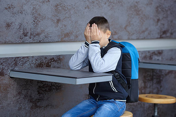 istock schoolboy crying on the street 617898236