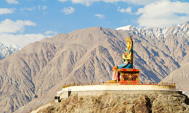 Giant Buddha Maitreya sitting statue in Nubra valley against the backdrop of the Himalayan mountains (Nubra, northern India)
