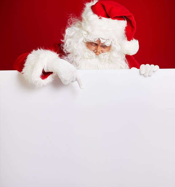 istock Santa Claus pointing in blank advertisement banner isolated on r 617899264