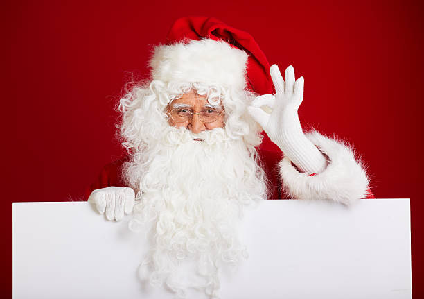 istock Santa Claus pointing in blank advertisement banner isolated on r 617899290