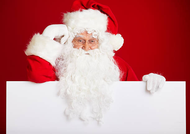 istock Santa Claus pointing in blank advertisement banner isolated on r 617899338