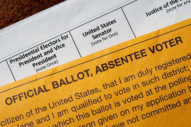 US absentee official voting ballot New York, United States - October 25, 2016: US Presidential absentee ballot photographed on a table with Government supplied envelope as a conceptual editorial still life absentee ballot photos stock pictures, royalty-free photos & images
