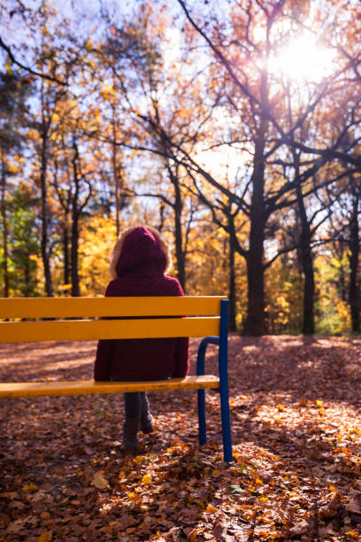 istock Woman in autumn park 617902310