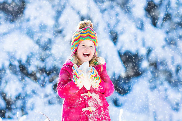 istock Child having fun in snowy winter forest 617903716