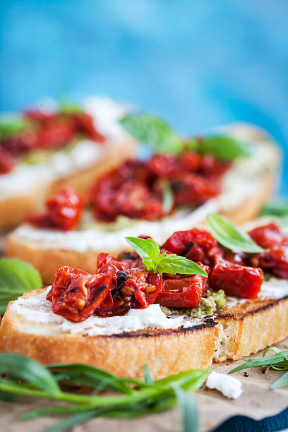 istock Bruschetta with cream cheese, pesto,  basil and sun dried t 617903728