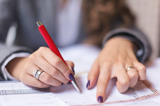 istock Close up of female hands writing 617905050