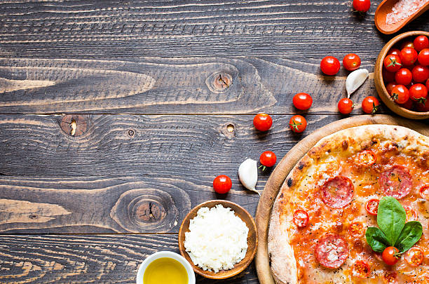 istock Hot Italian pizza on a rustic wooden table. 617905316