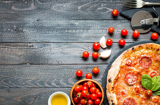 istock Hot Italian pizza on a rustic wooden table. 617905448