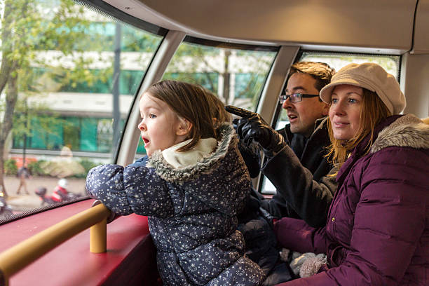 family look in wonder on london bus - bus family travel destinations women imagens e fotografias de stock