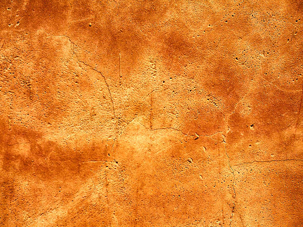 istock background made with a texture of a orange wall 617906214