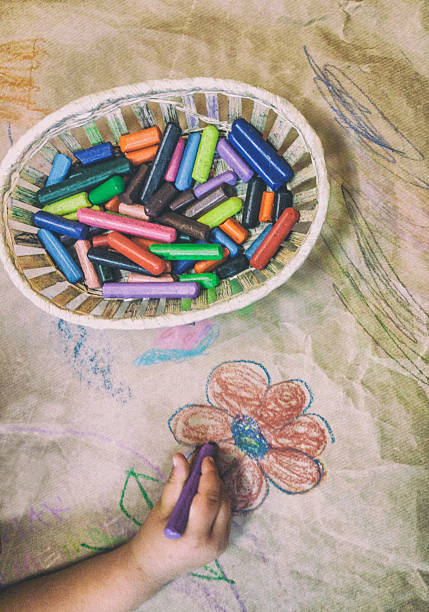 istock Child drawing with wax crayons over wrapping 617906670
