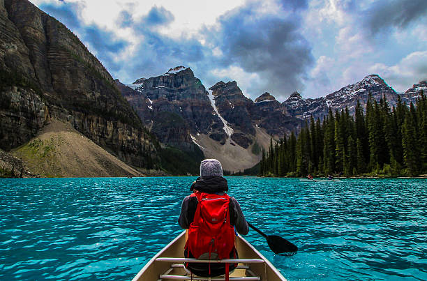 Canoeing on Moraine Lake My fiance and I canoeing on the incredible turquoise water of Moraine Lake, in Banff National Park.  alberta photos stock pictures, royalty-free photos & images