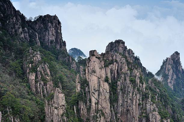 istock Flow of clouds in  Huangshan mountains valleys 05 618024822