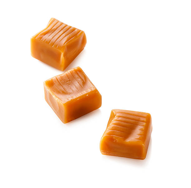 istock three toffee caramel candies close-up isolated on white background 618024828