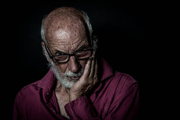istock Senior man with beard with lonely and sad expression 618025750