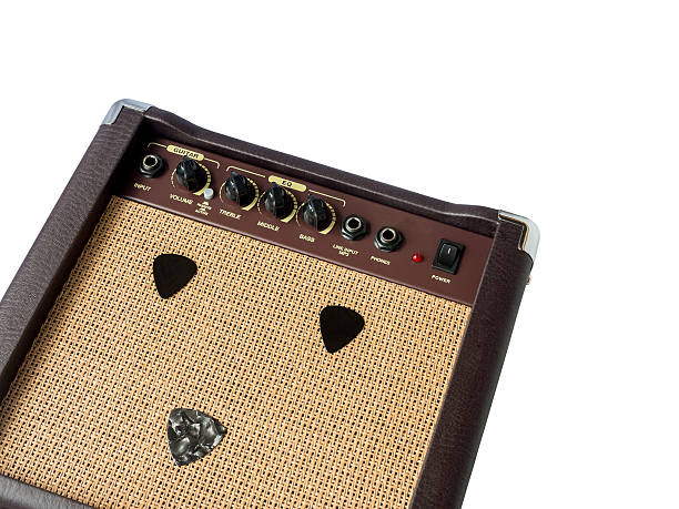 istock Small acoustic guitar amplifier with pick guitar on amplifier ma 618027252