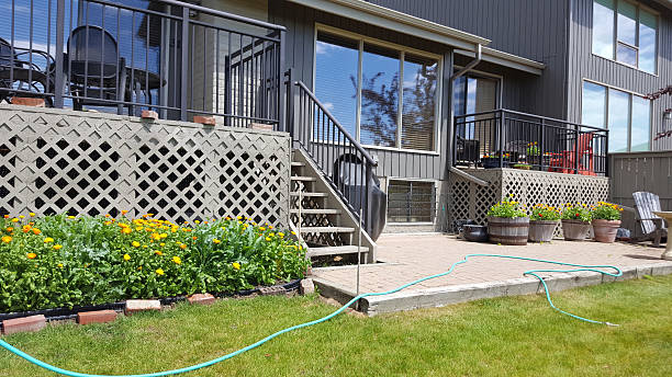 Back view of my condo. Two decks plus patio. Outdoor furniture. Some green space.