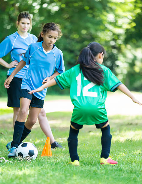 istock Female soccer player blocks kick 618029618