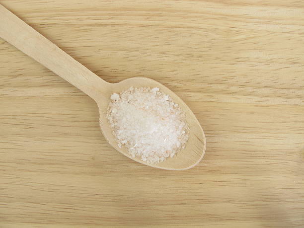 istock Six grams of salt per day on a wooden spoon 618030458