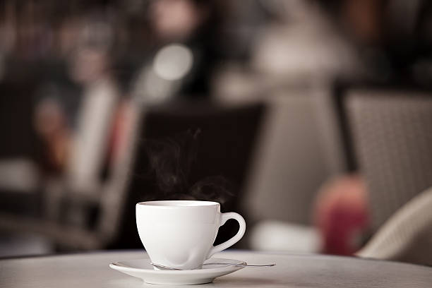 istock White cup of coffee at the summer cafe table 618030828