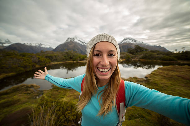 istock Hiker takes selfie portrait in mountain scenery 618033024