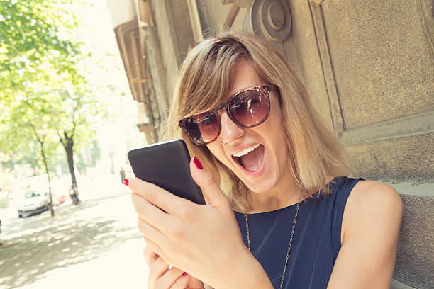 istock Girl using cellphone outdoors. 618035580