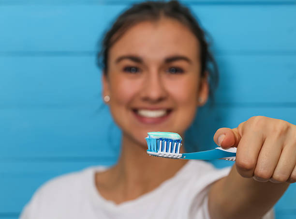 istock girl with toothbrush and toothpaste 618035742