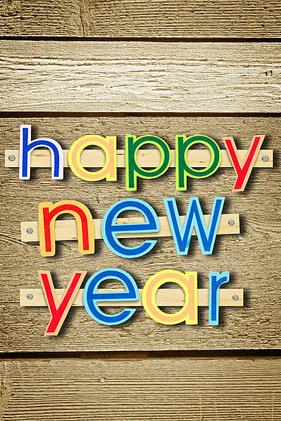 istock Nailed greeting text Happy New Year on wooden background 618036376