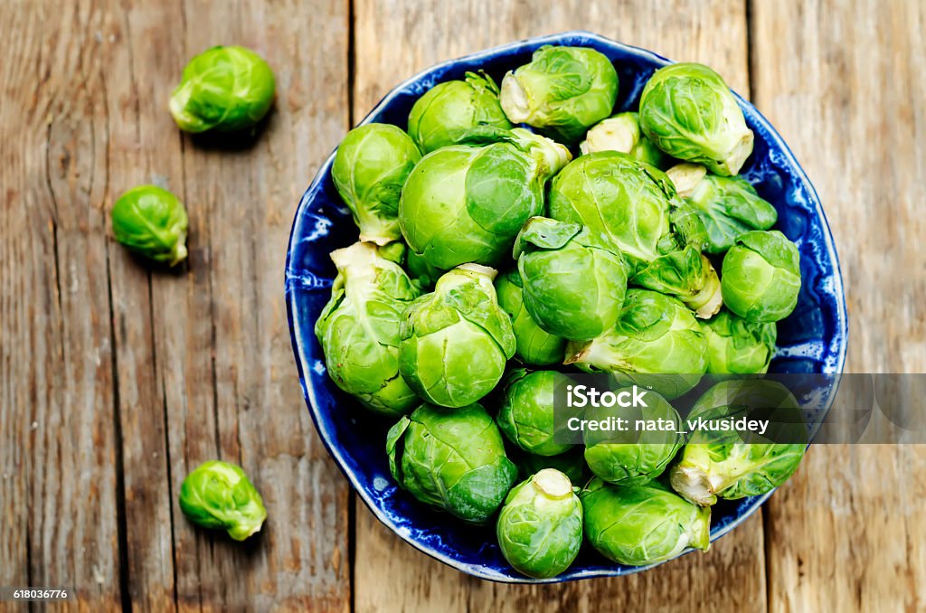 Brussels sprouts in a wooden bowl Brussels sprouts in a wooden bowl. toning. selective focus Brussels Sprout Stock Photo