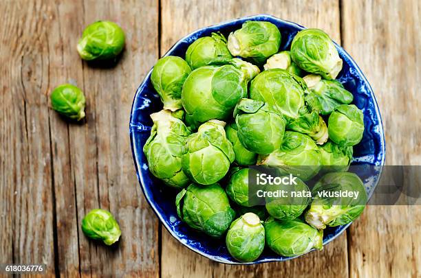Brussels Sprouts In A Wooden Bowl Stock Photo - Download Image Now - Brussels Sprout, Cabbage, Crucifers