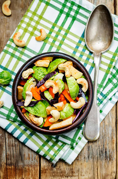 istock Brussels sprouts red cabbage carrot cashew apple salad 618037978
