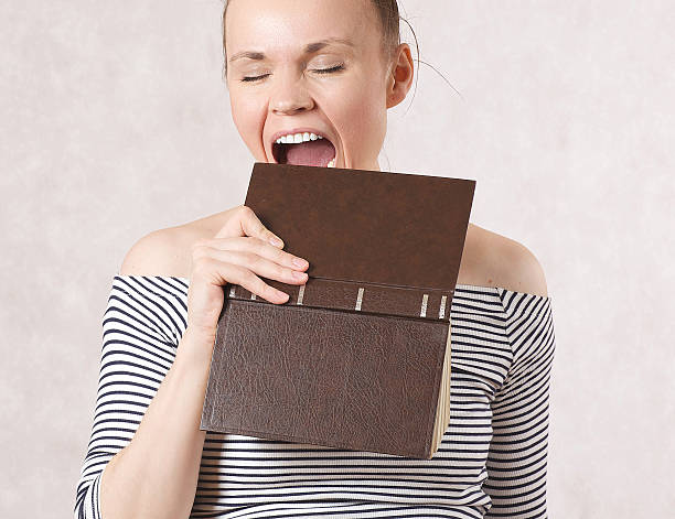istock Young woman and a hardback book. 618038088