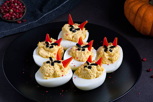 Deviled eggs, party snack Party snack appetizer: deviled (stuffed) eggs with cute funny faces. Good for kids party or Halloween party stuffing food photos stock pictures, royalty-free photos & images