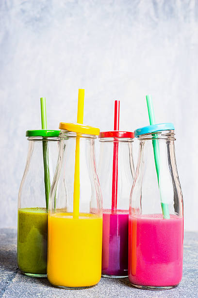 istock Vitamin smoothie in bottles with straws on light background 618041366