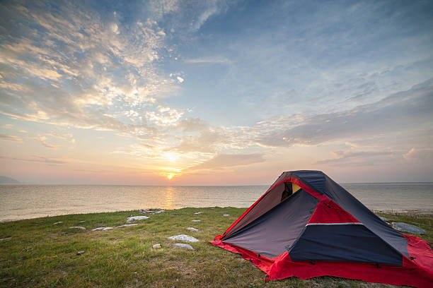 istock Tent on seashore in the morning 618042174