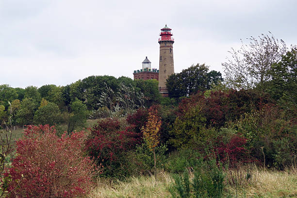 istock lighthouse with small store at Cape Arkona. Autumn stormy weathe 618042850