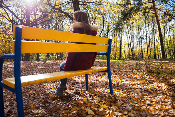 istock Woman in autumn park 618043248