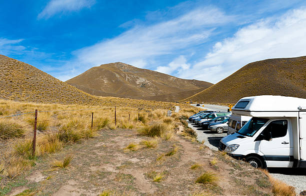 Car park at Lindis Pass, New Zealand Otago, New Zealand - February 1, 2016: Car park at scenic lookout of Lindis Pass on State Highway 8 (Tarras - Omarama - Lindis Pass Road), lies between the valleys of the Lindis and Ahuriri Rivers, south island of New Zealand. omarama stock pictures, royalty-free photos & images