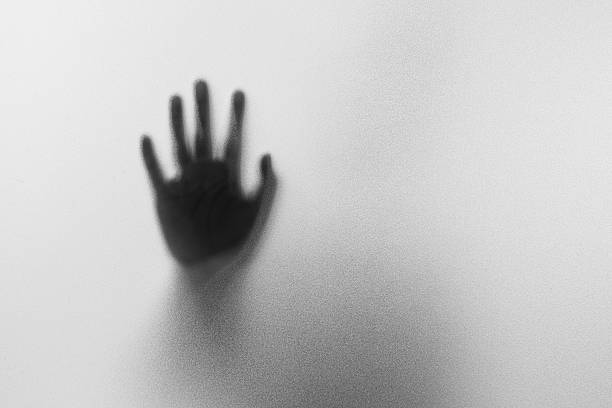 istock Shadow hands of the Man behind frosted glass. 618043922