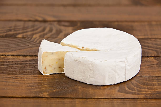 istock Fresh brie cheese with white mold on a white background 618044704