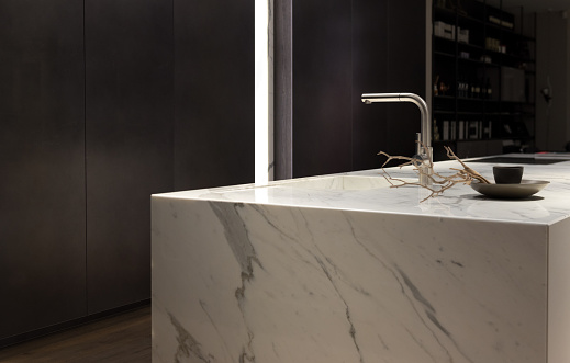 Stylish Solid White Marble Kitchen Counter With Dark Cupboards